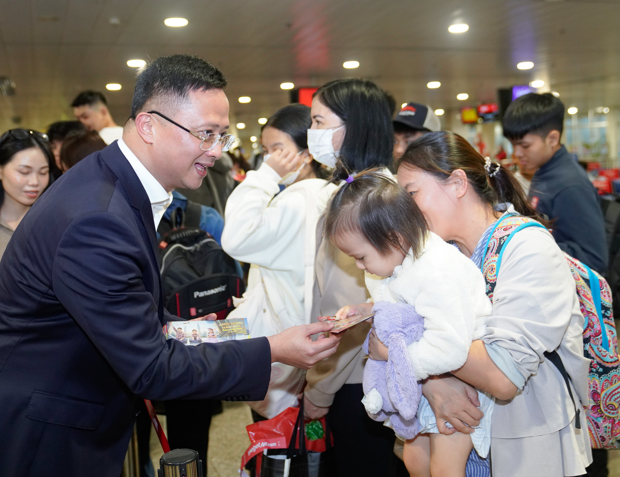 A person giving a child a ticket to a personDescription automatically generated