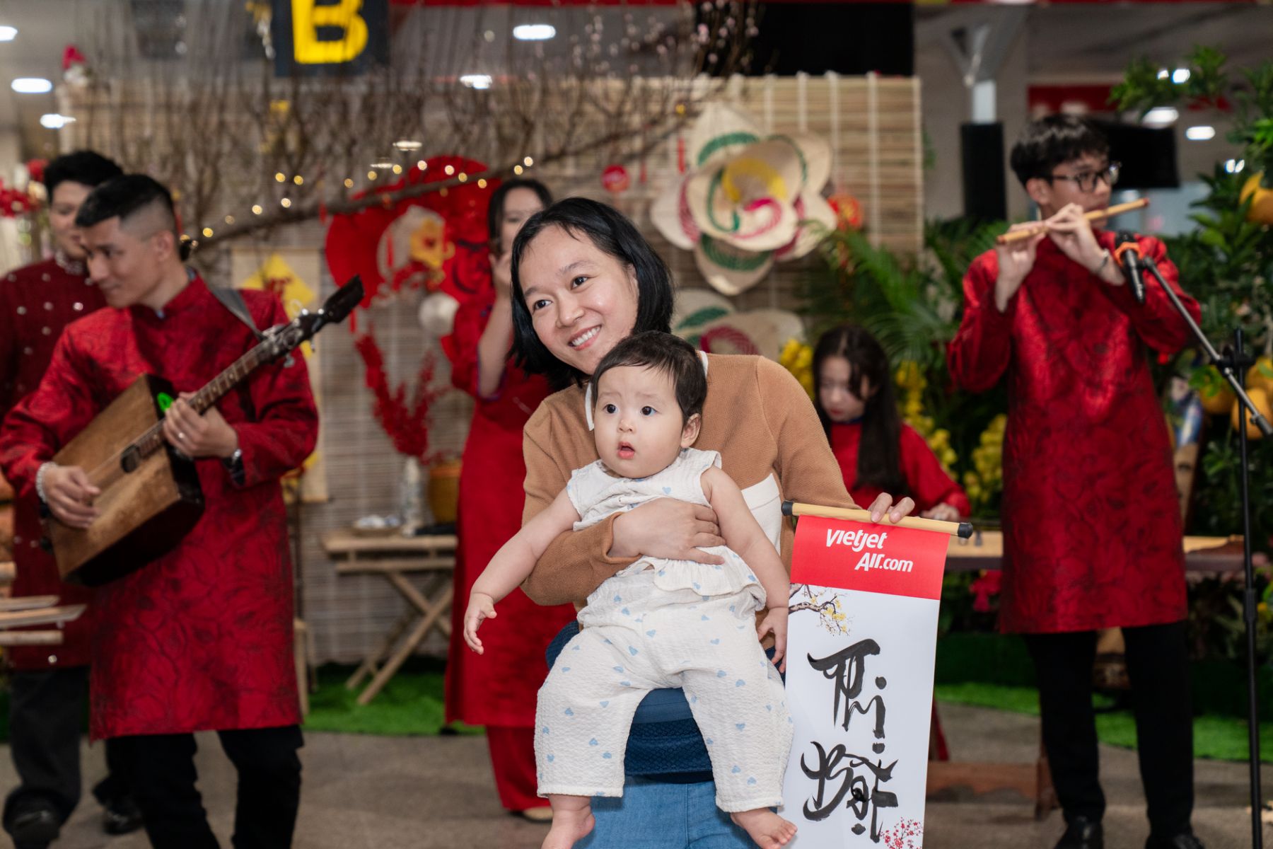 A person holding a babyDescription automatically generated