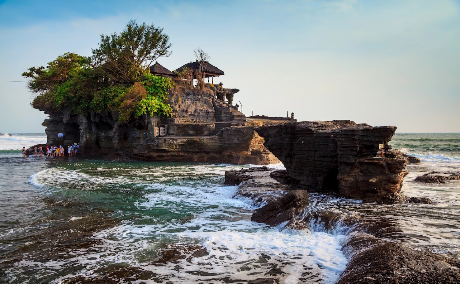 The sacred Tanah Lot Temple perched on a rock formation in the sea of Bali.